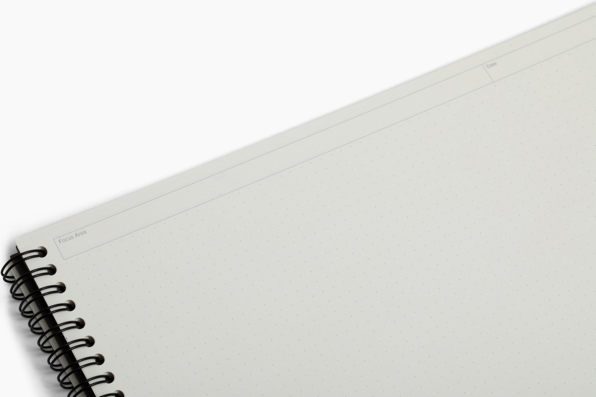 Inside pages of the Plana Pro notebook showcasing dedicated sections for Focus Area and Date on a white background