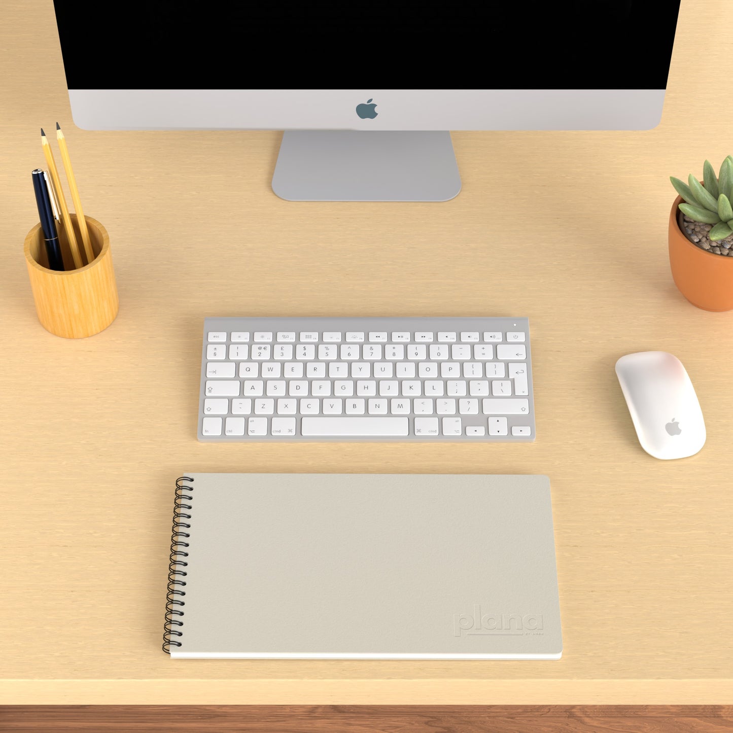 Plana Classic Fog on a wooden desk with a computer, pen holder, and plant